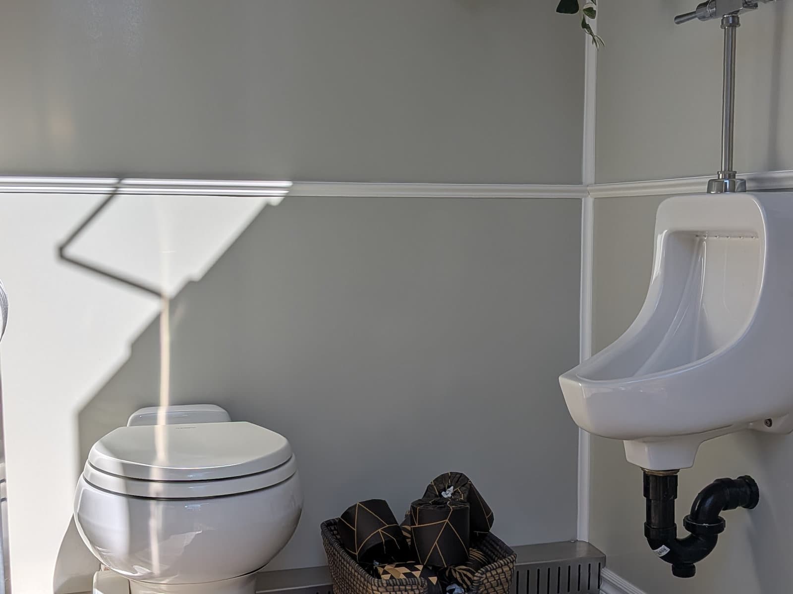 Interior flushing toilet and urinal finished in soft grey